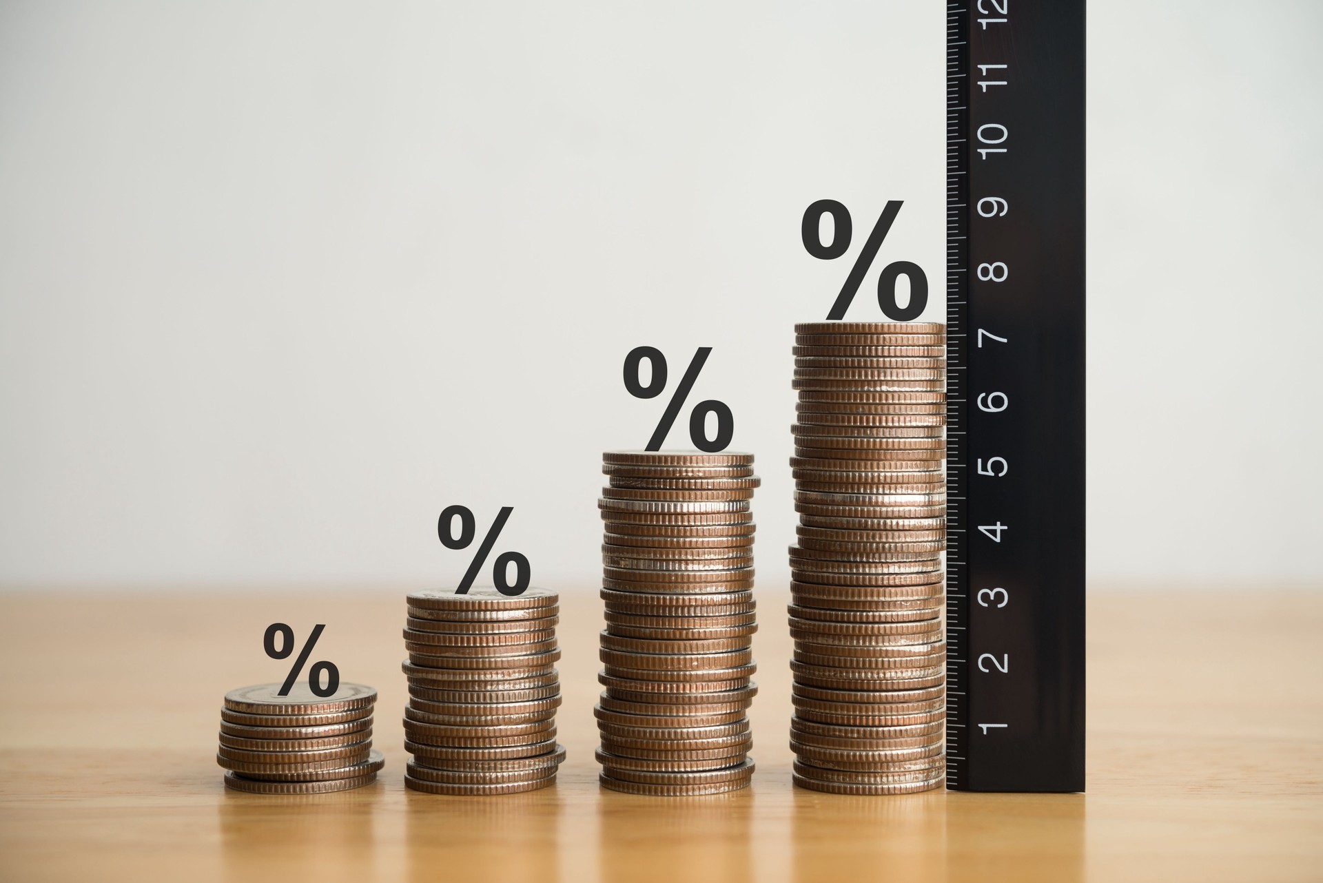 Growth stack coins chart with percent sign and measure ruler.