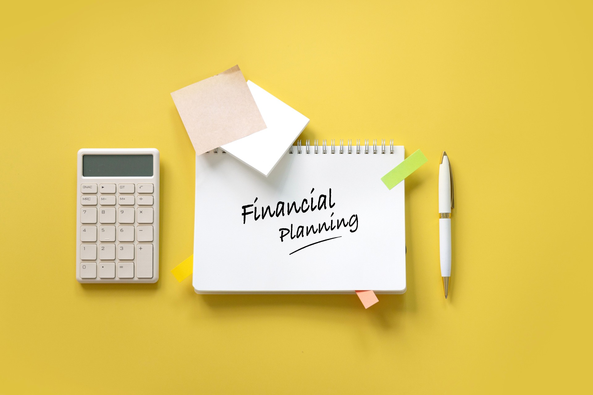 Financial planning concepts objects with text "Financial planning" on yellow background still life.